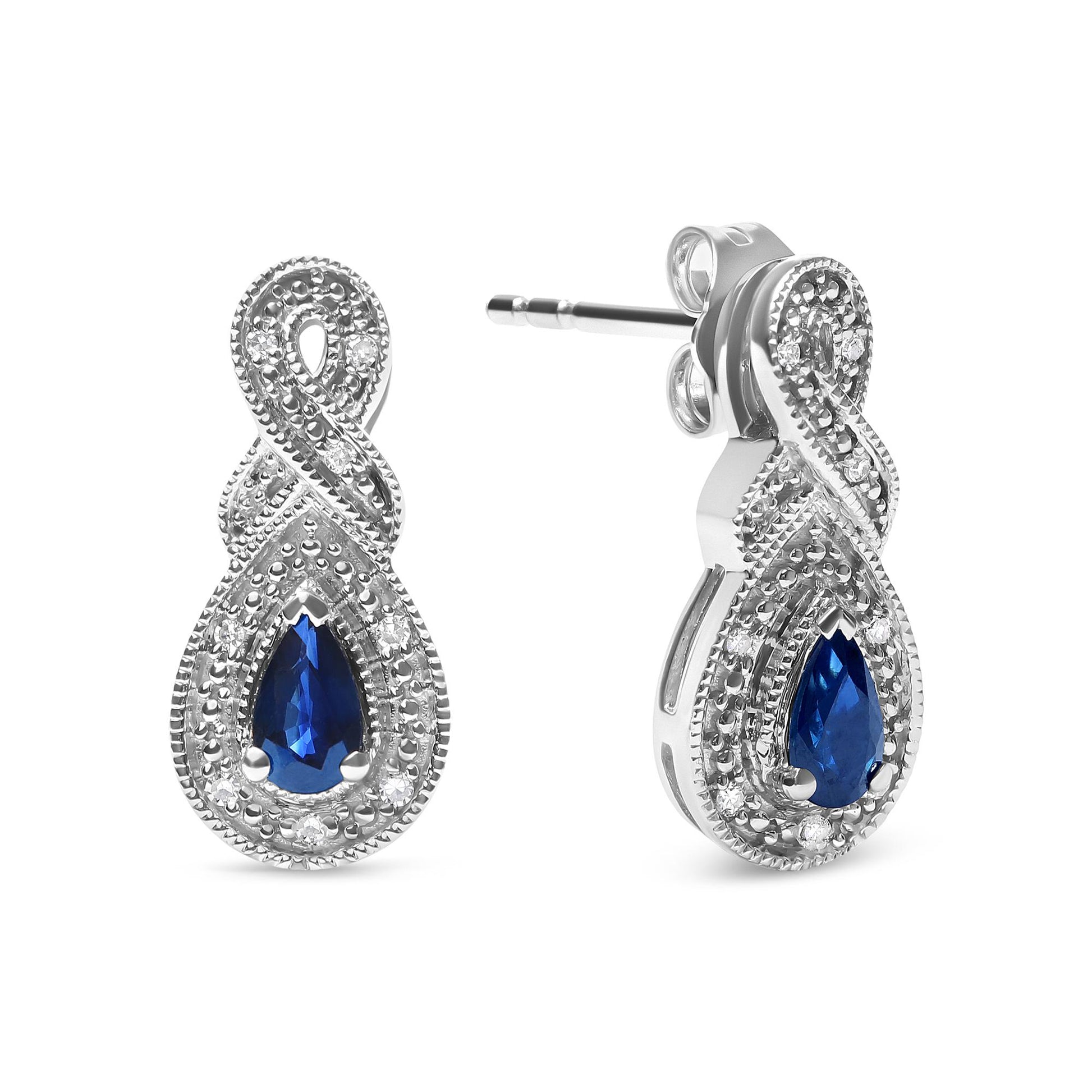 Pair of white metal earrings with an infinity loop design, featuring round white gemstones and a pear-shaped blue gemstone center, shown from front and side angles.