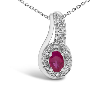 Close-up front angle of a white metal necklace pendant featuring an oval red gemstone in a prong setting, surrounded by small round white gemstones in a pave setting, shown on a chain against a white background.