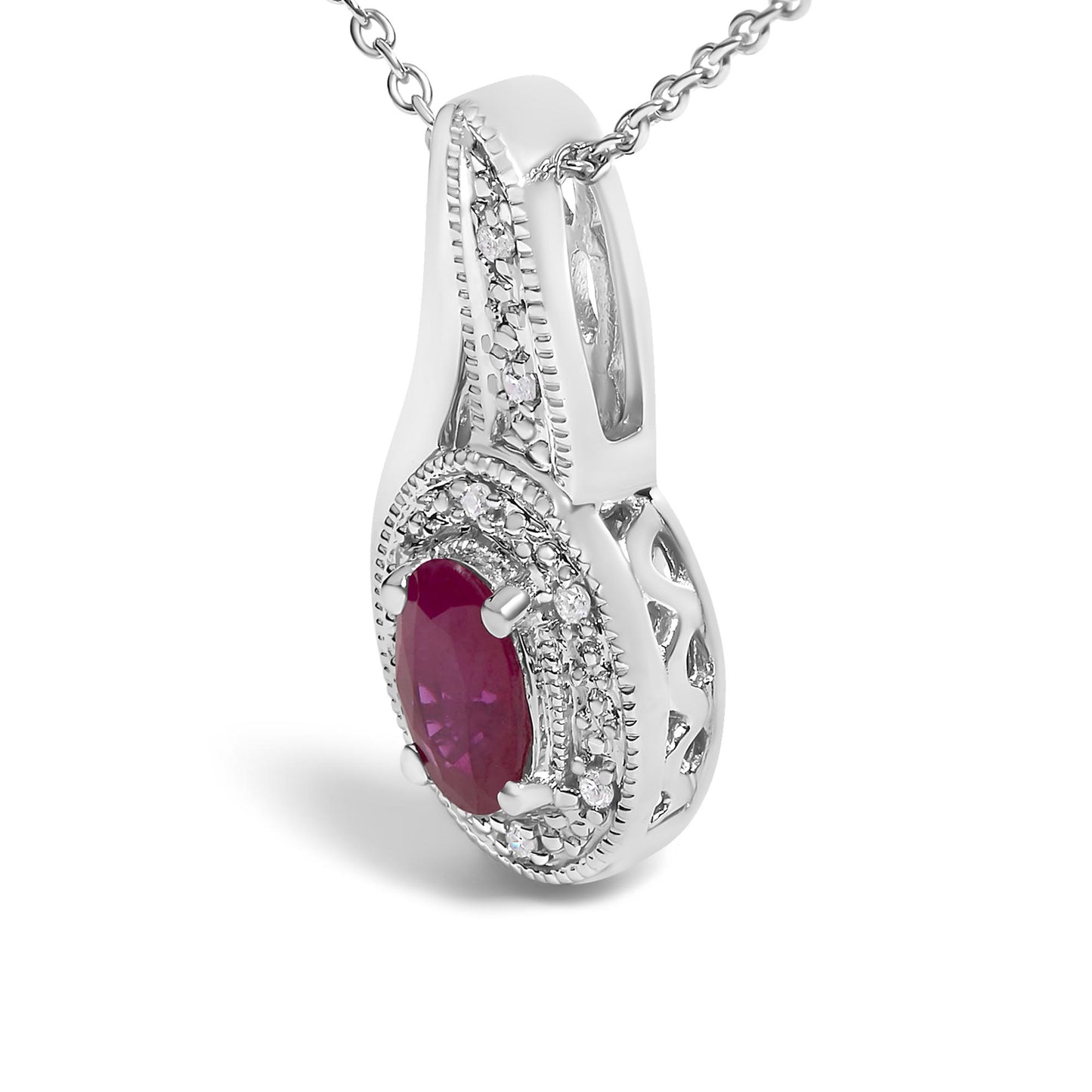 Close-up front angle of a white metal necklace pendant featuring an oval red gemstone in the center surrounded by small round white gemstones in a pave setting, shown hanging from a white metal chain.