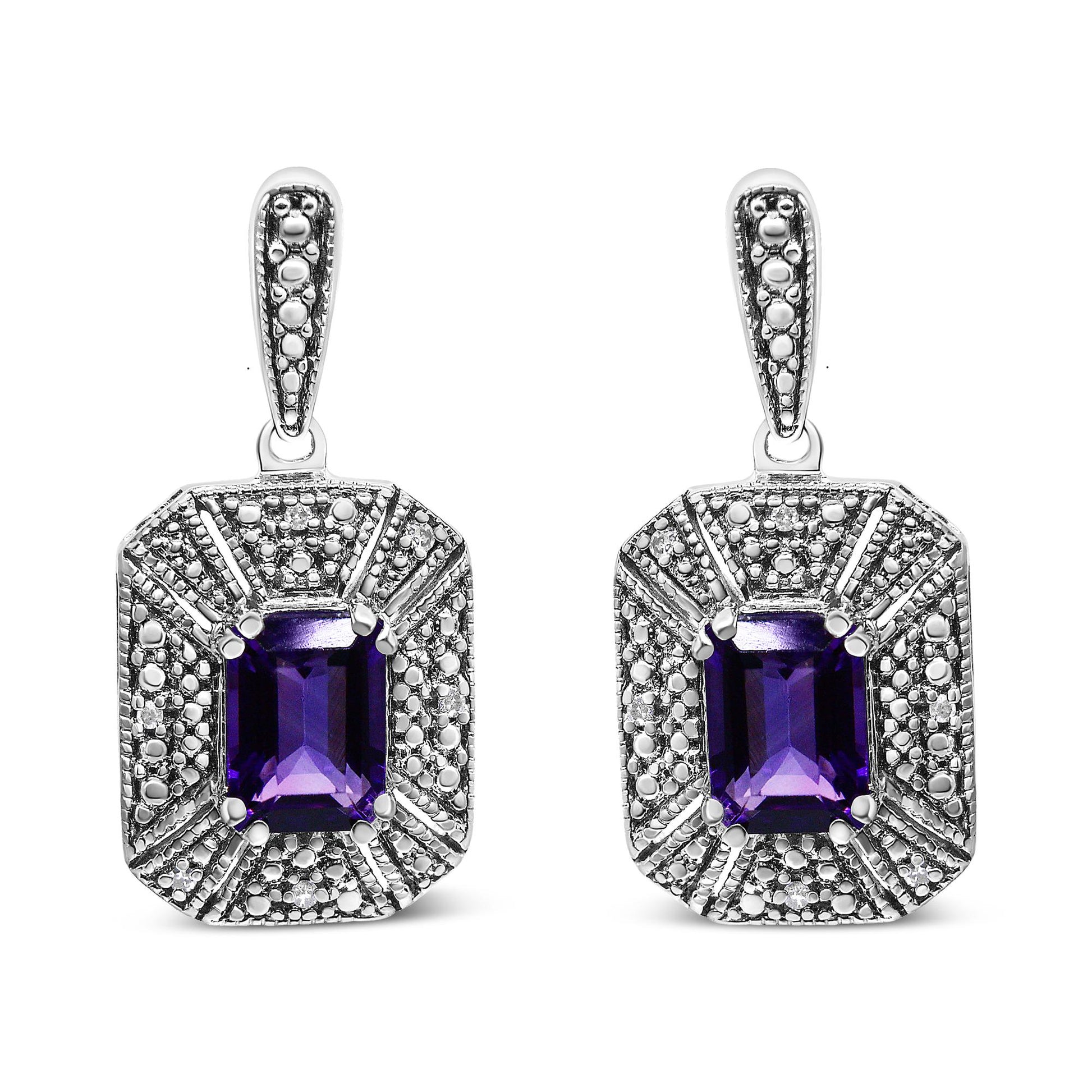 Pair of white metal earrings with rectangular purple gemstones in the center, surrounded by multiple small round white gemstones, shown from the front angle.