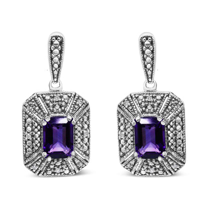 Pair of white metal earrings with rectangular purple gemstones in the center, surrounded by multiple small round white gemstones, shown from the front angle.
