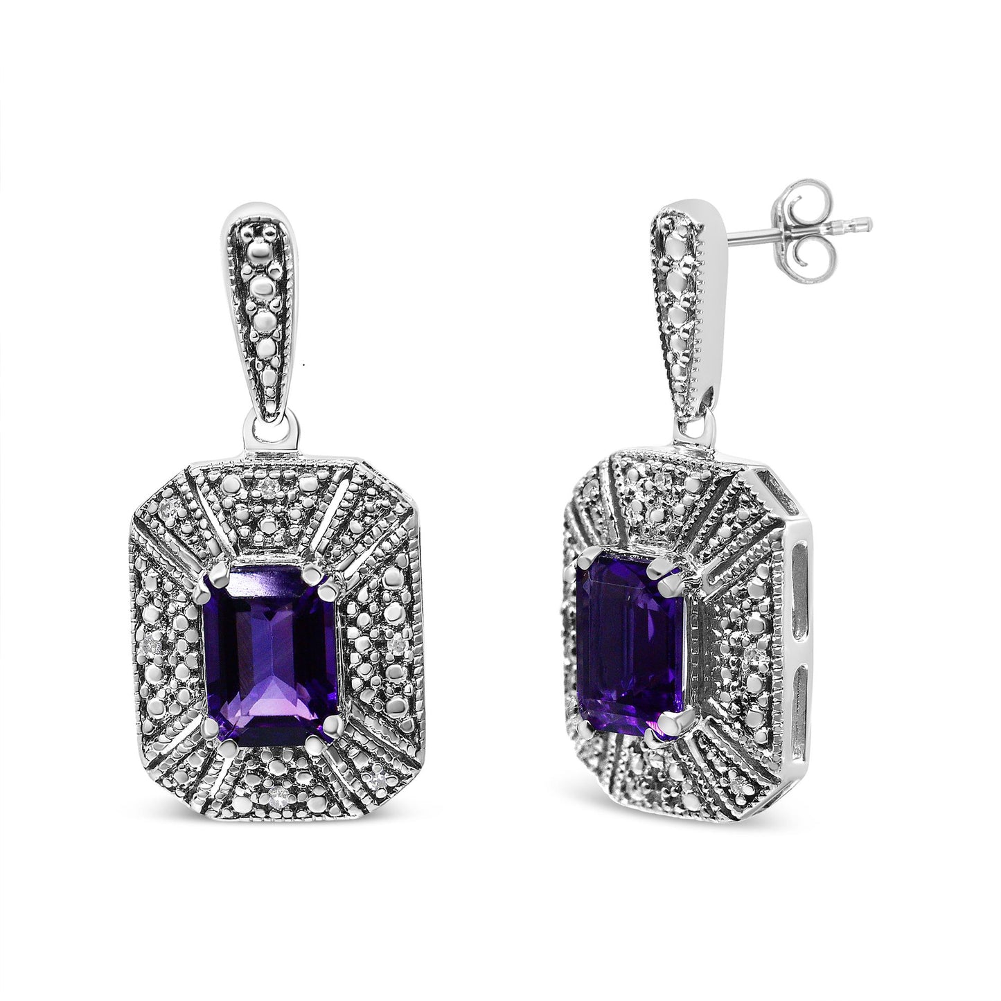 Pair of white metal earrings with purple emerald-shaped gemstones in center and surrounding round white gemstones, one earring shown from front and the other at a slight side angle.
