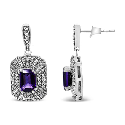 Front and side view of white metal earrings featuring a central purple emerald-shaped gemstone surrounded by round white gemstones in a prong setting, photographed on a white background.
