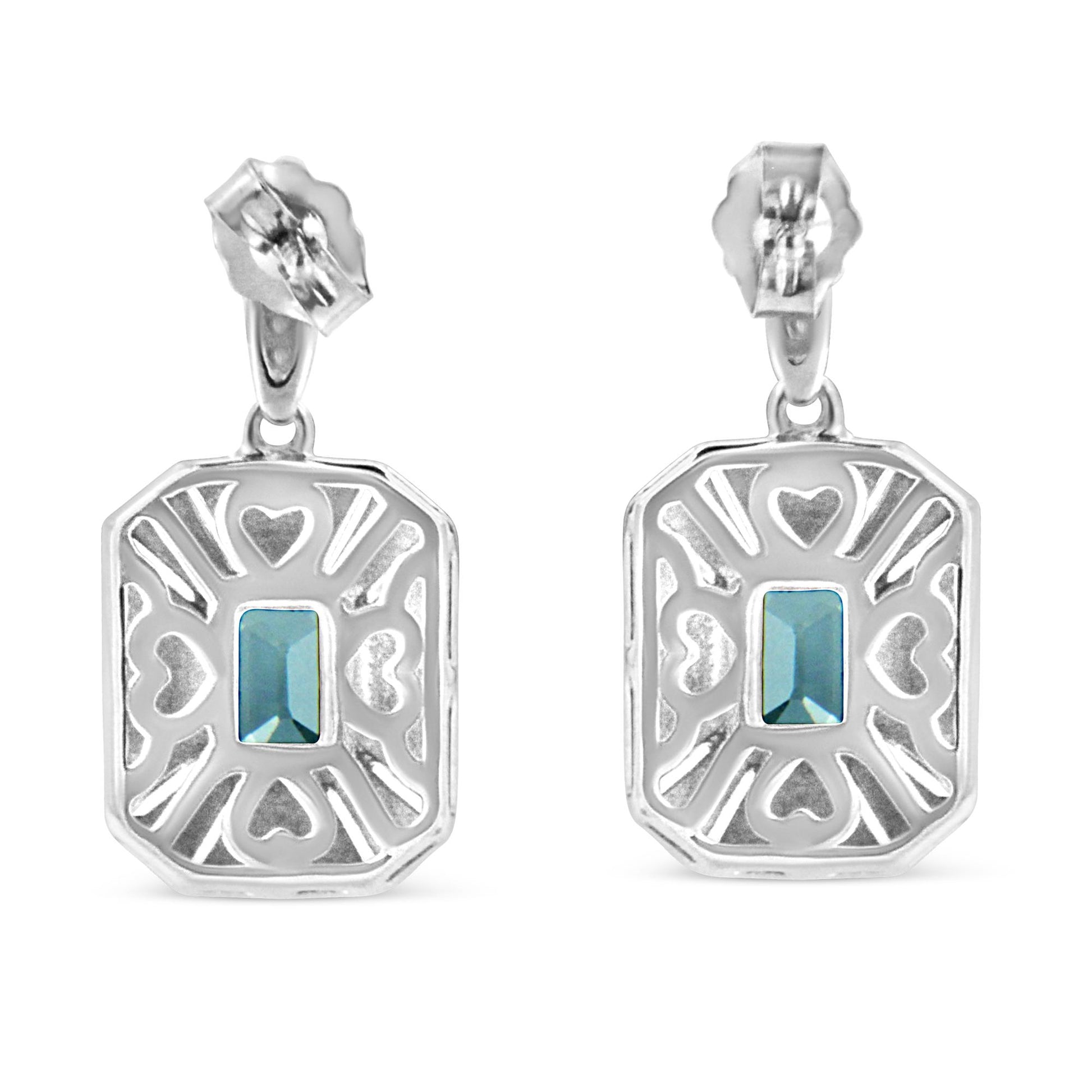 Front-facing view of white metal earrings with openwork heart and line patterns, each featuring a central blue rectangular gemstone in a prong setting.