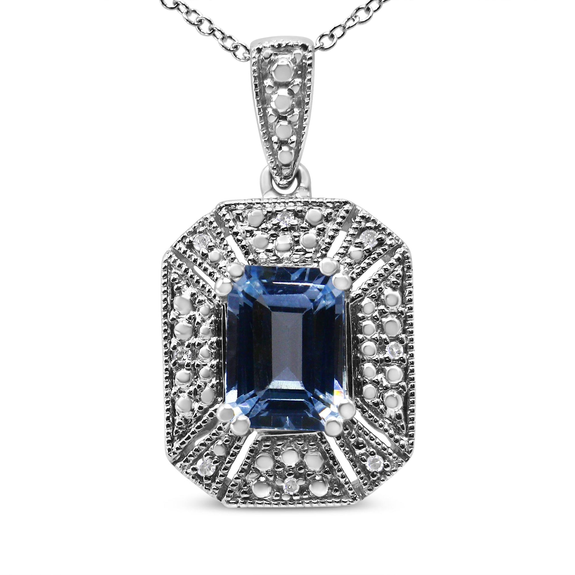 Front-facing shot of a white metal necklace pendant with a rectangular blue gemstone in the center, surrounded by round white gemstones in a prong setting.
