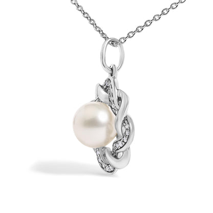 Close-up front view of a white metal necklace pendant with a large round pearl and an intertwined design encrusted with white gemstones, shown on a white background.