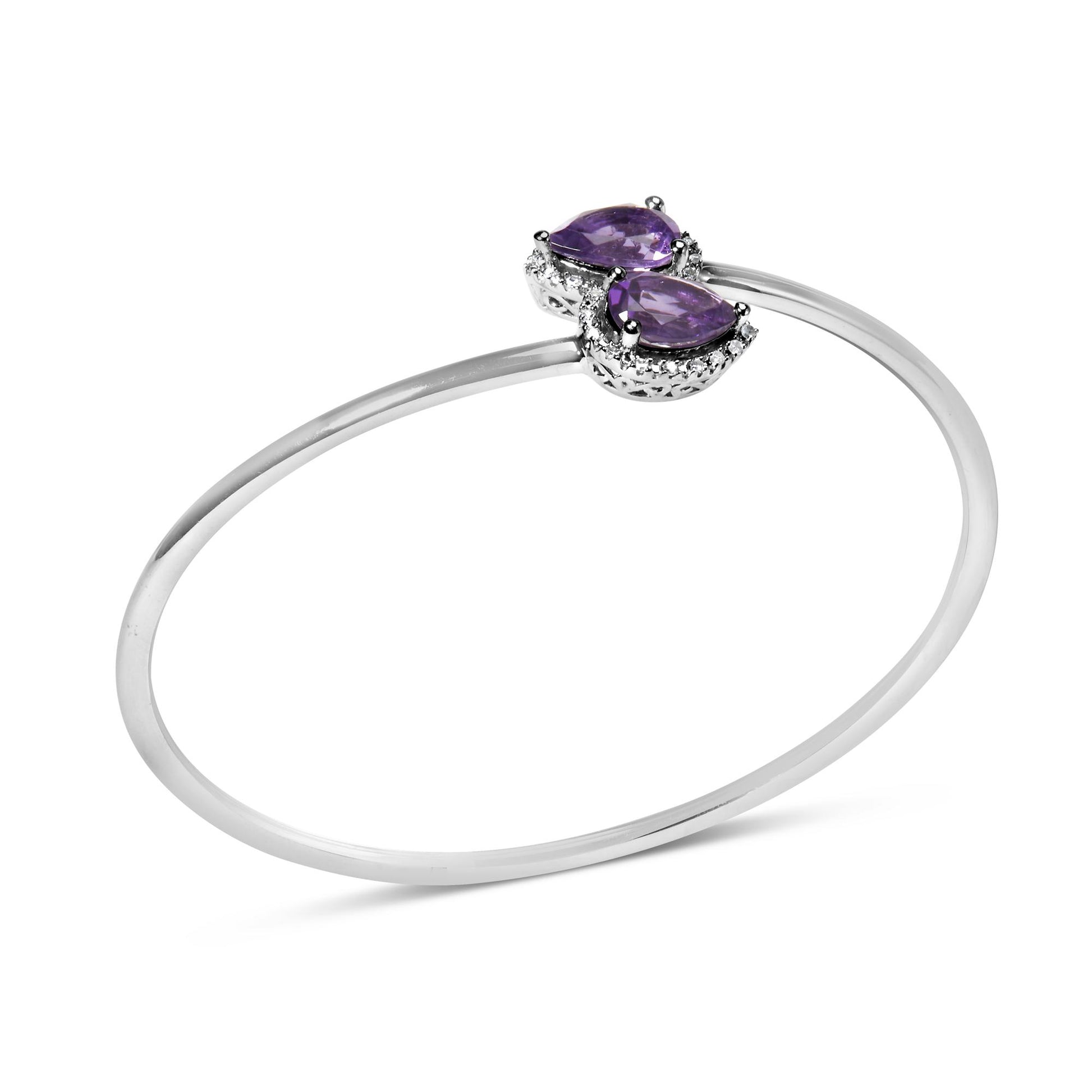 White metal open bangle bracelet with two pear-shaped purple gemstones surrounded by small round white gemstones, shown at a slight angle on a white background.