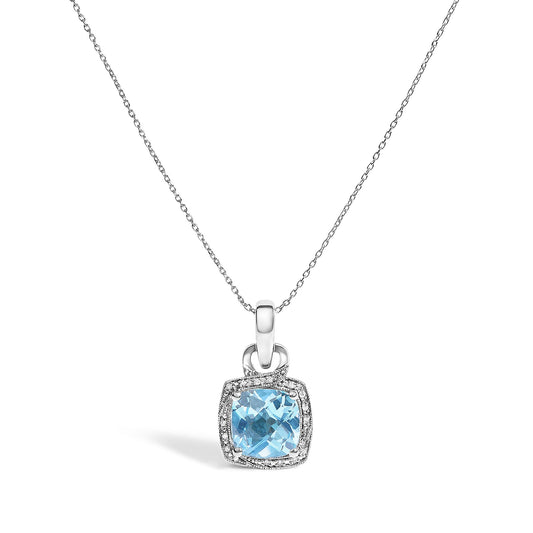 Close-up front angle of a white metal necklace with a pendant featuring a cushion-shaped blue gemstone surrounded by small round white gemstones.