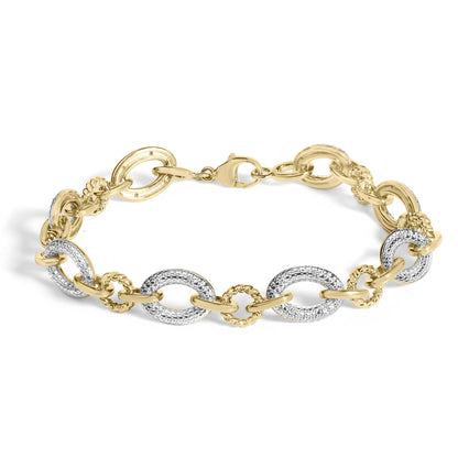 Close-up image of a yellow metal bracelet with alternating smooth and textured oval links, some featuring white gemstones in a pave setting, shown on a white background.