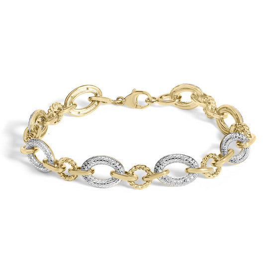 Close-up image of a yellow metal bracelet with alternating smooth and textured oval links, some featuring white gemstones in a pave setting, shown on a white background.