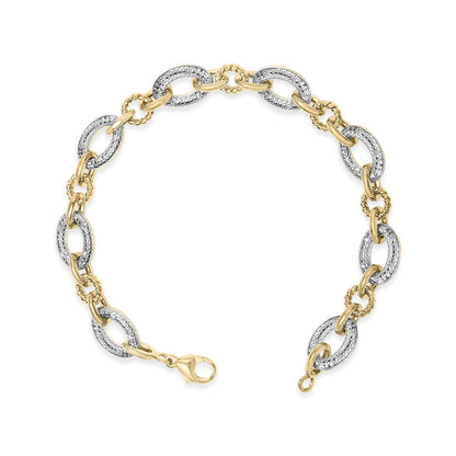 Top-down view of a yellow metal bracelet with alternating smooth and textured oval links, the textured links set with white gemstones in a pave setting, shown flat on a white background.