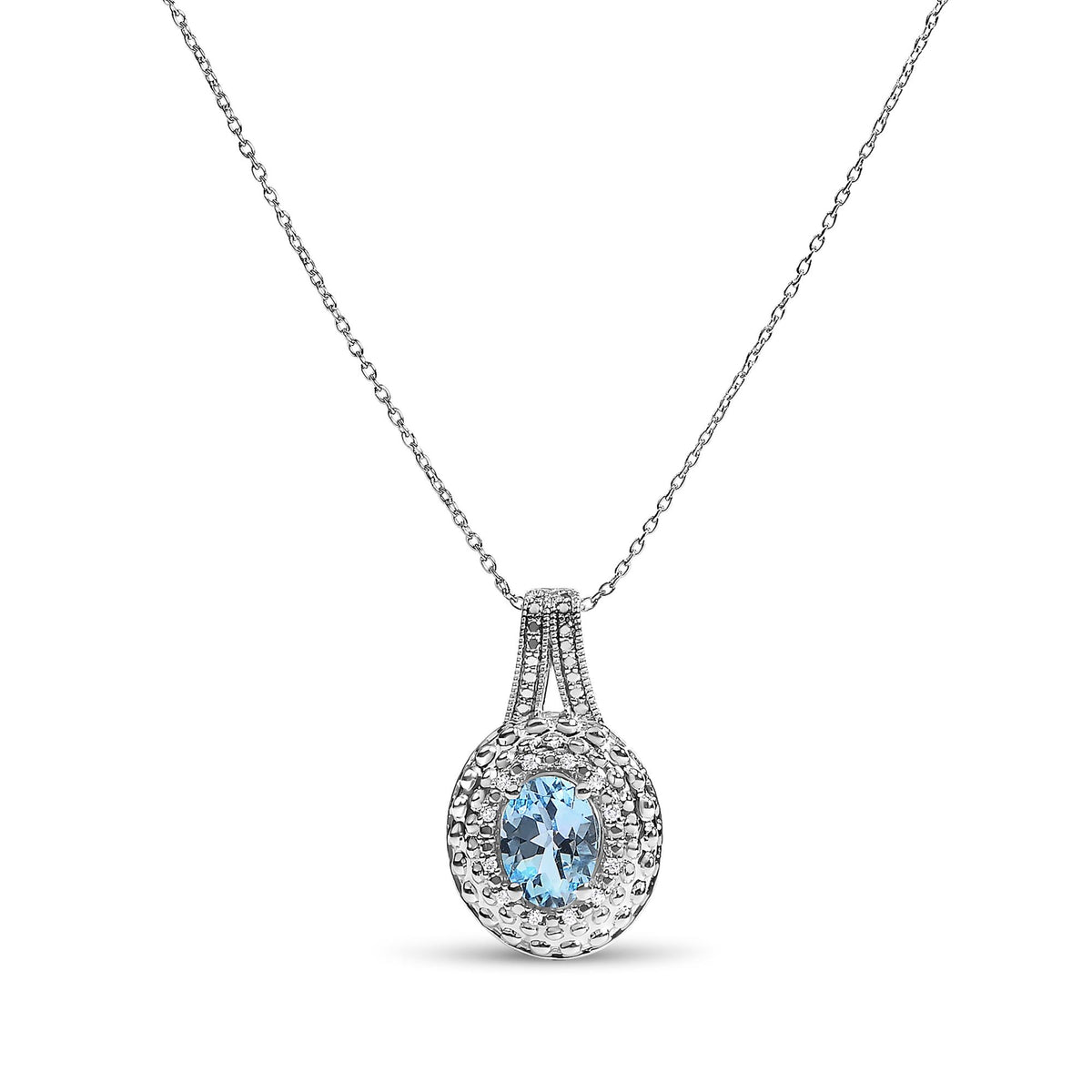 Close-up front angle of a white metal necklace with a pendant featuring an oval blue gemstone surrounded by round white gemstones in pave setting.