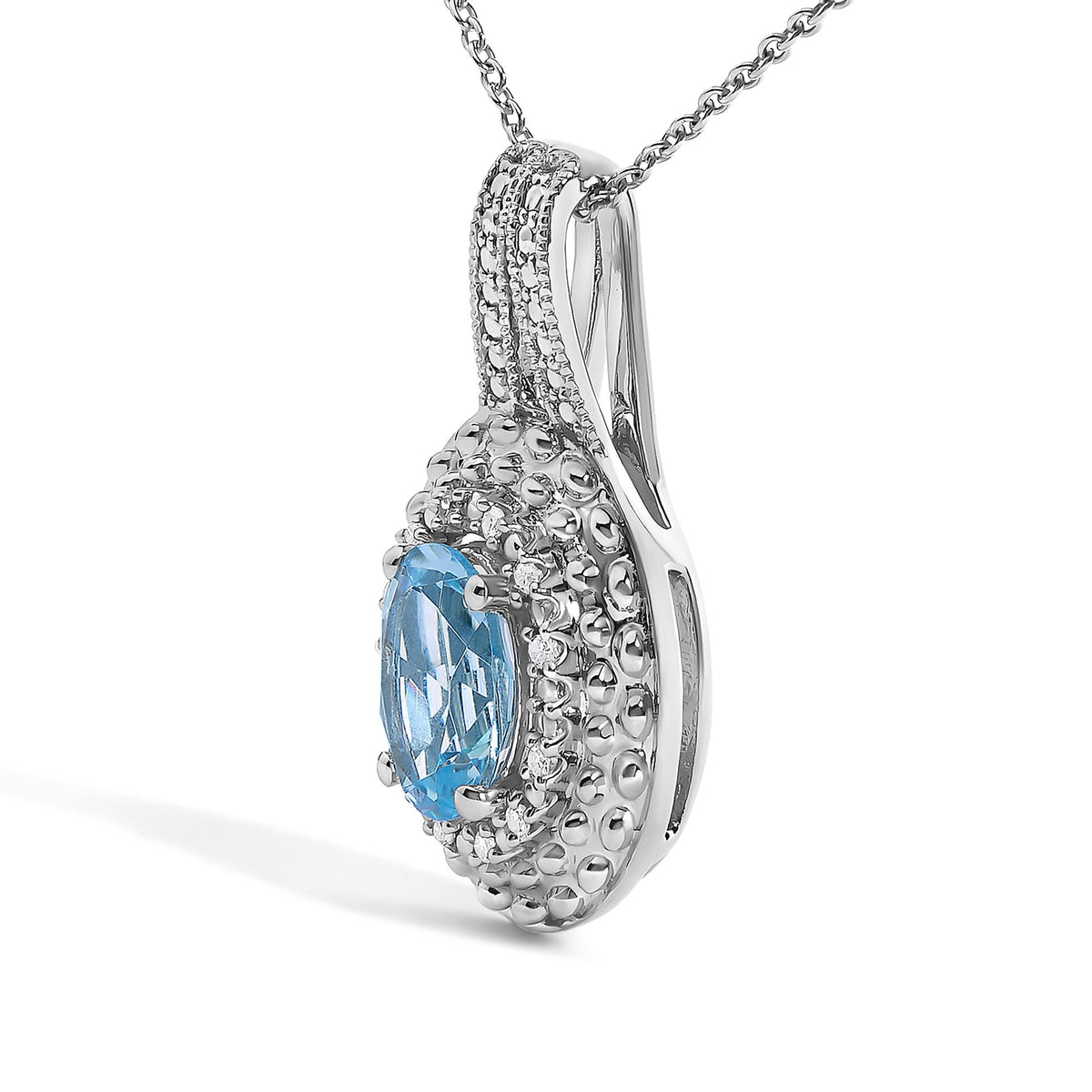 Close-up front angle of a white necklace pendant featuring an oval blue gemstone surrounded by pave set round white gemstones, attached to a white chain.