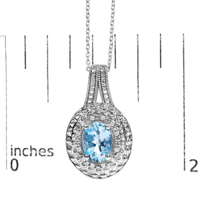 Close-up front view of a white necklace pendant with a central oval blue gemstone surrounded by small round white gemstones in a pave setting, shown on a measurement scale.