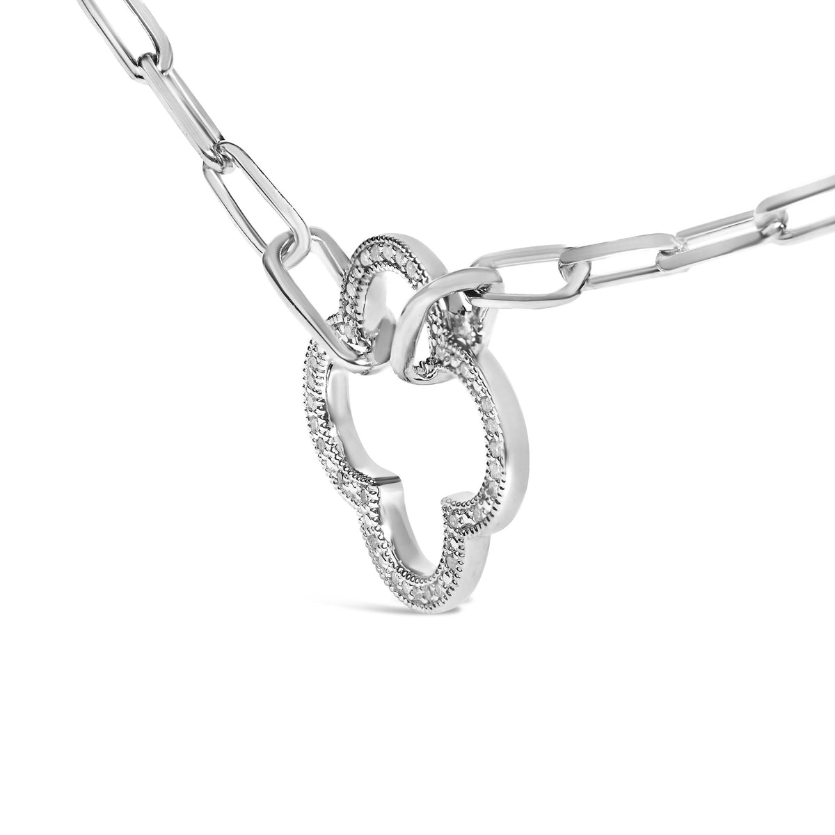 Close-up angled view of a white metal necklace chain with a pendant featuring interlocking oval shapes adorned with round white gemstones in a pave setting.