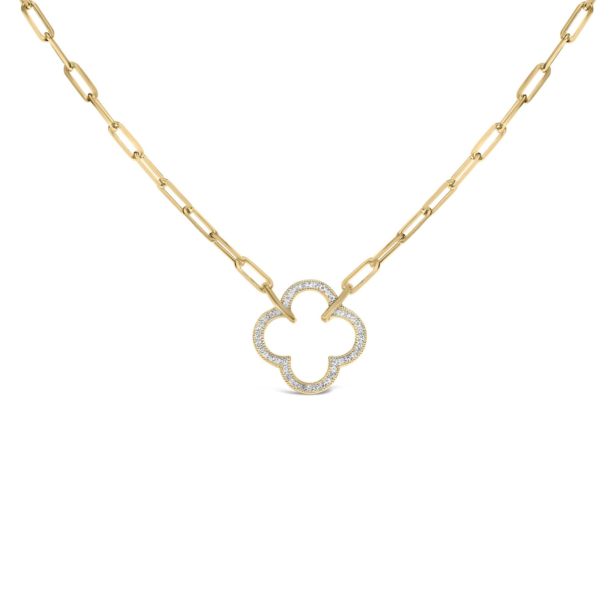 Close-up front view of a yellow necklace with elongated chain links and a quatrefoil-shaped pendant encrusted with white gemstones in a pave setting.