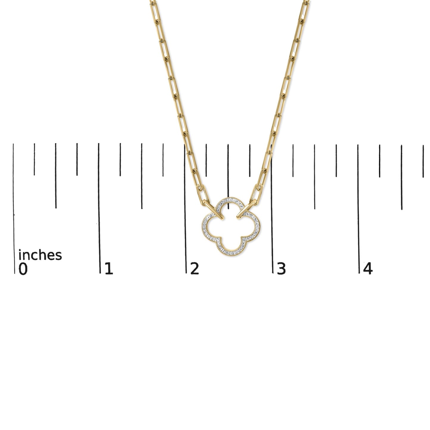 Close-up front view of a yellow necklace with a quatrefoil-shaped pendant outlined with small white gemstones, shown on a scale marked in inches.