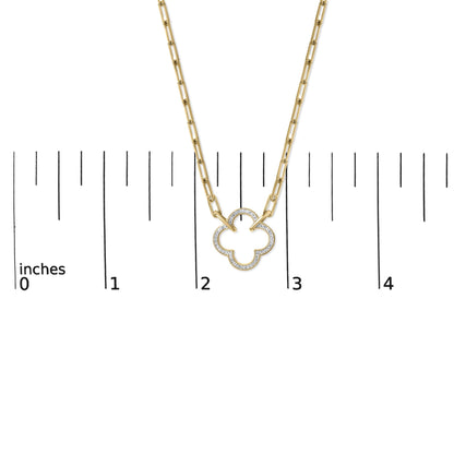 Close-up front view of a yellow necklace with a quatrefoil-shaped pendant outlined with small white gemstones, shown on a scale marked in inches.