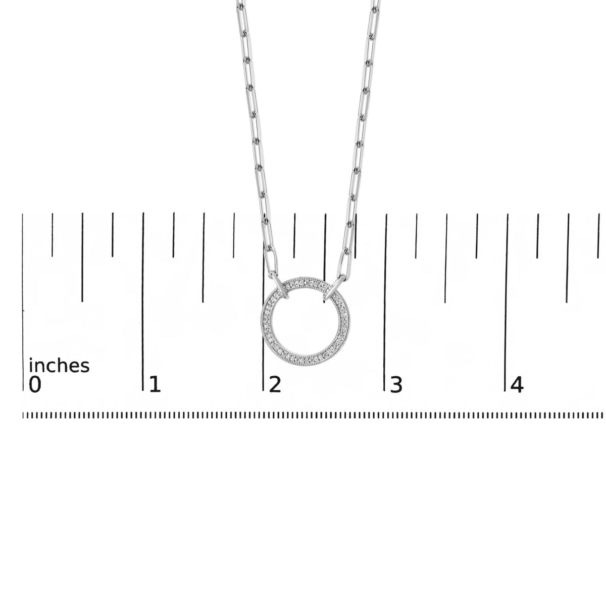 Close-up front view of a white necklace with a circular pendant featuring pave-set white round gemstones, shown on a measurement scale.