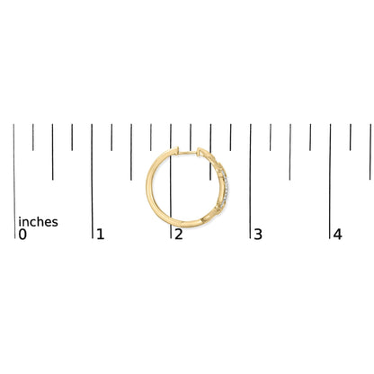 Close-up front view of a single yellow hoop earring with a row of small white gemstones in a pave setting, shown on a ruler for scale.