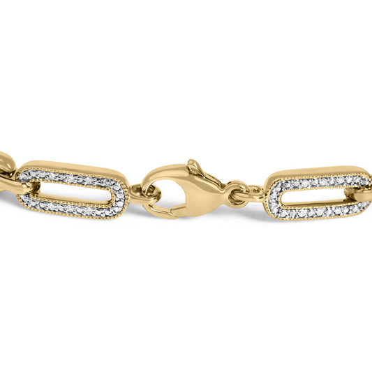 Close-up front-angle view of a yellow metal bracelet with oval-shaped links, each outlined with pavé-set white gemstones, featuring a clasp in the center.