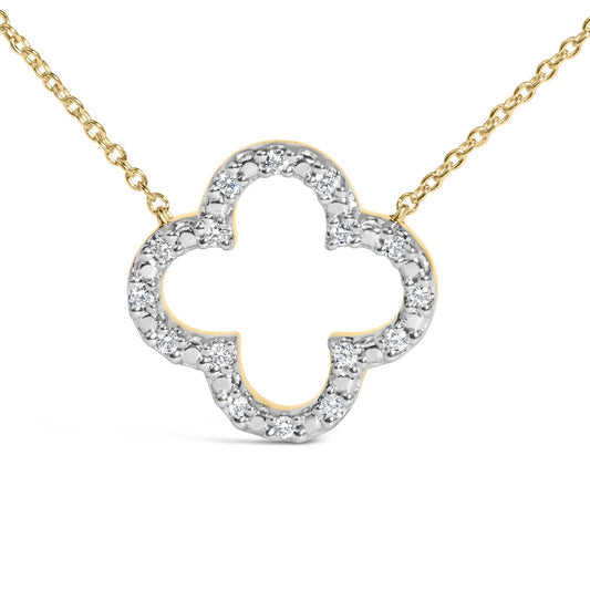 Close-up front angle of a yellow metal necklace with a clover-shaped pendant adorned with round white gemstones in prong settings.