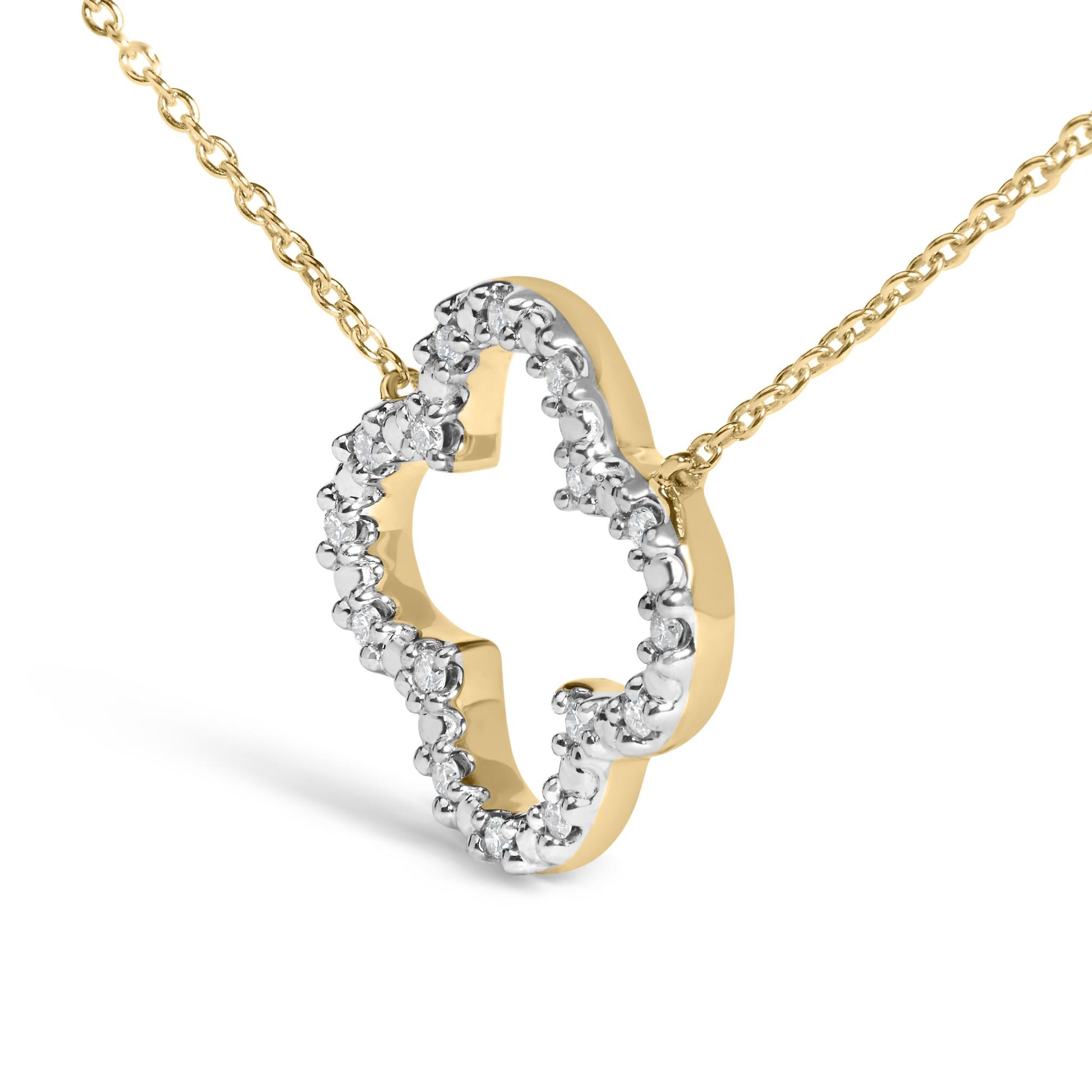 Close-up, angled view of a yellow metal necklace pendant in a heart shape accented with round white gemstones in prong settings along the outer edge, shown on a white background.