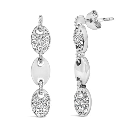 Close-up front and side view of white metal drop earrings with linked oval shapes, featuring pave-set round white gemstones.
