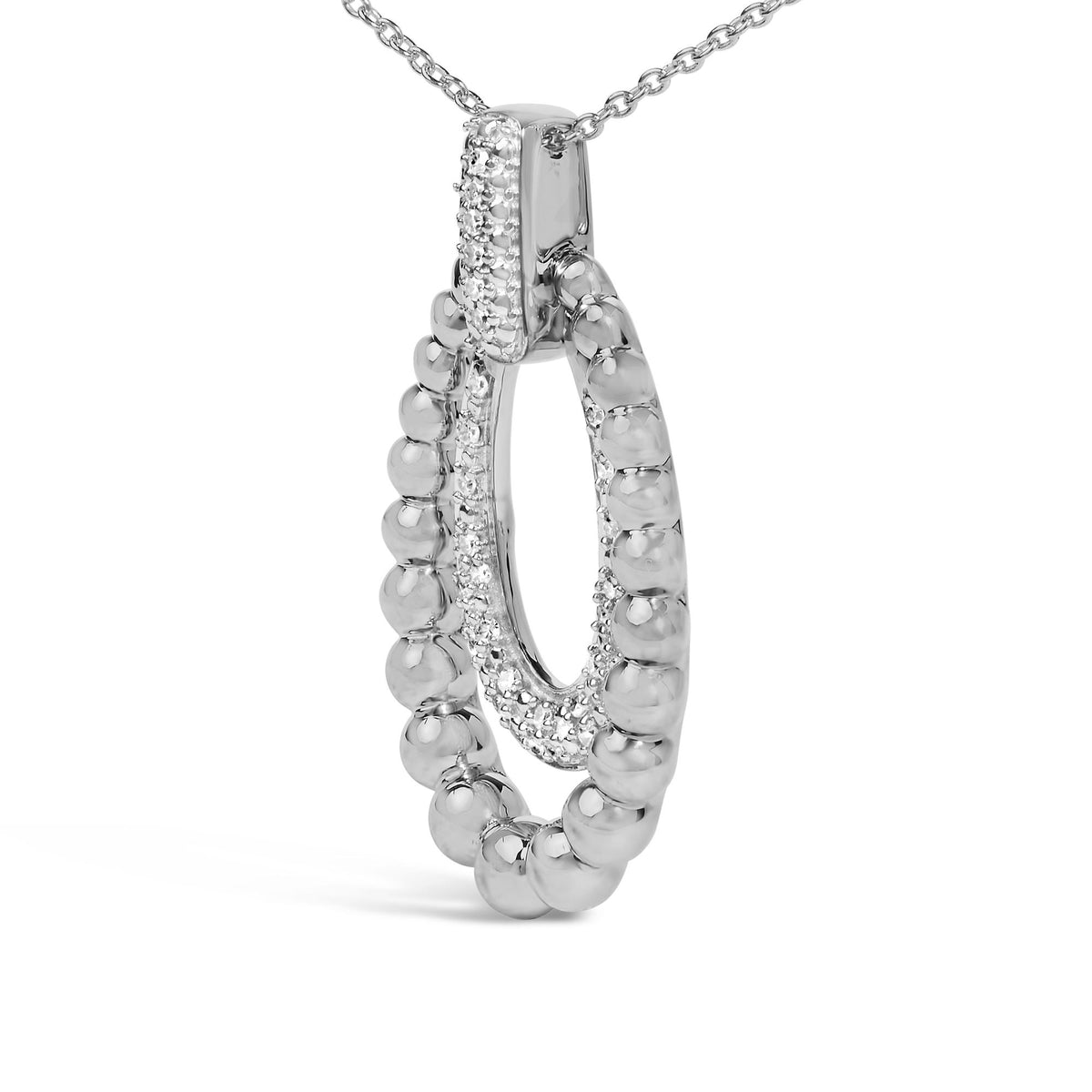 Close-up front angle of a white metal necklace pendant with an oval shape featuring small round white gemstones in a pave setting along the inner edge and smooth rounded beads along the outer edge.