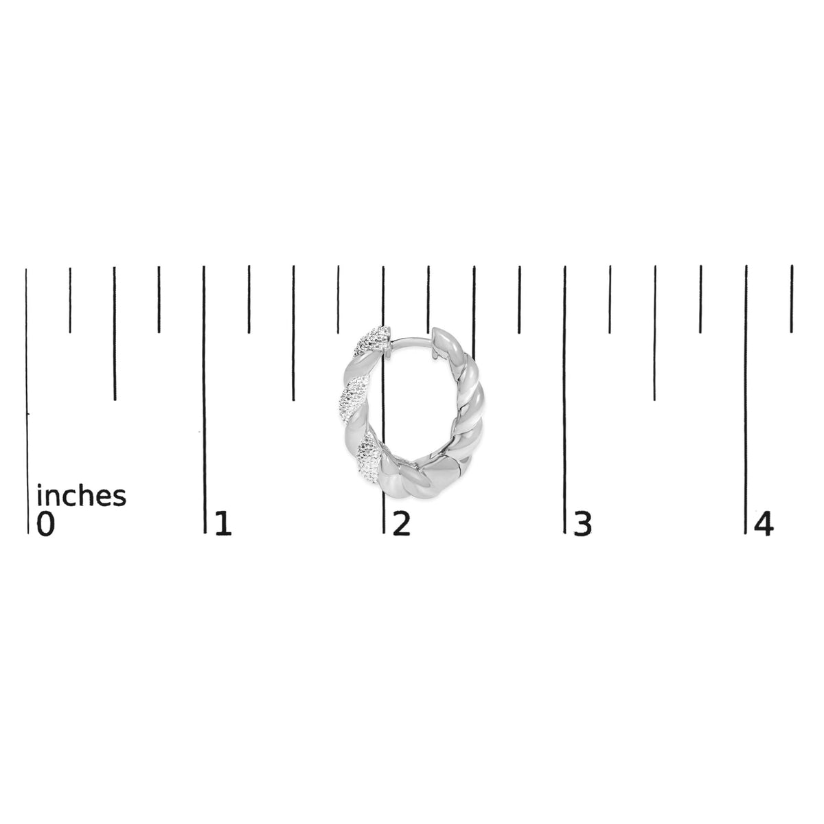 Close-up front view of a white twisted hoop earring with sections set with small white gemstones, shown on a ruler for scale.