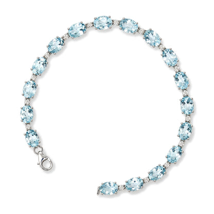 Close-up front angle of a white metal bracelet featuring alternating oval blue gemstones and round white gemstones in prong settings, shown on a white background.