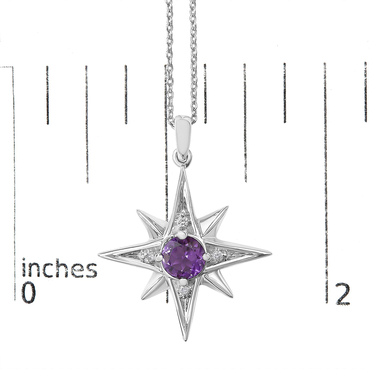 White necklace with starburst-shaped pendant featuring a central round purple gemstone surrounded by round white gemstones, shown on a scale, front angle.