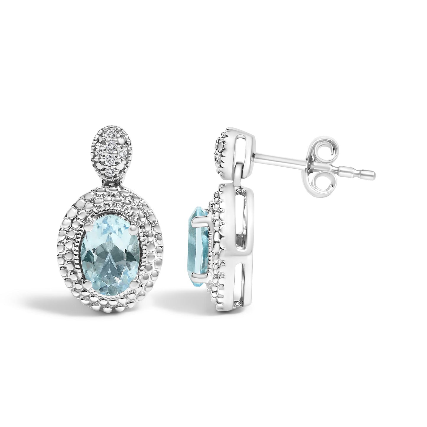 Pair of white metal oval-shaped earrings with blue oval gemstones at the center, surrounded by pave-set small white round gemstones, shown in front and side view on a white background.