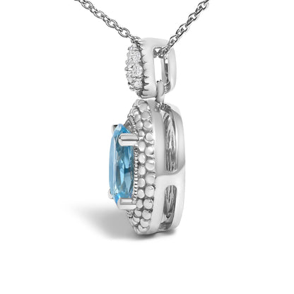 Side view of a white metal necklace pendant featuring an oval blue gemstone in prong setting surrounded by multiple round white gemstones in pave setting, shown against a white background.