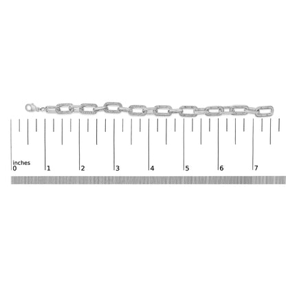 White metal bracelet with alternating plain and gemstone-set rectangular links shown flat on a ruler, shot from the front.