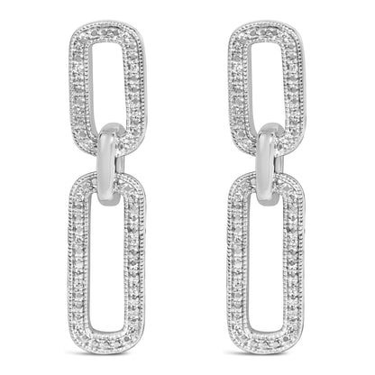Close-up front view of white metal dangling earrings with two connected rectangular links, each outlined with small white gemstones in a pave setting.