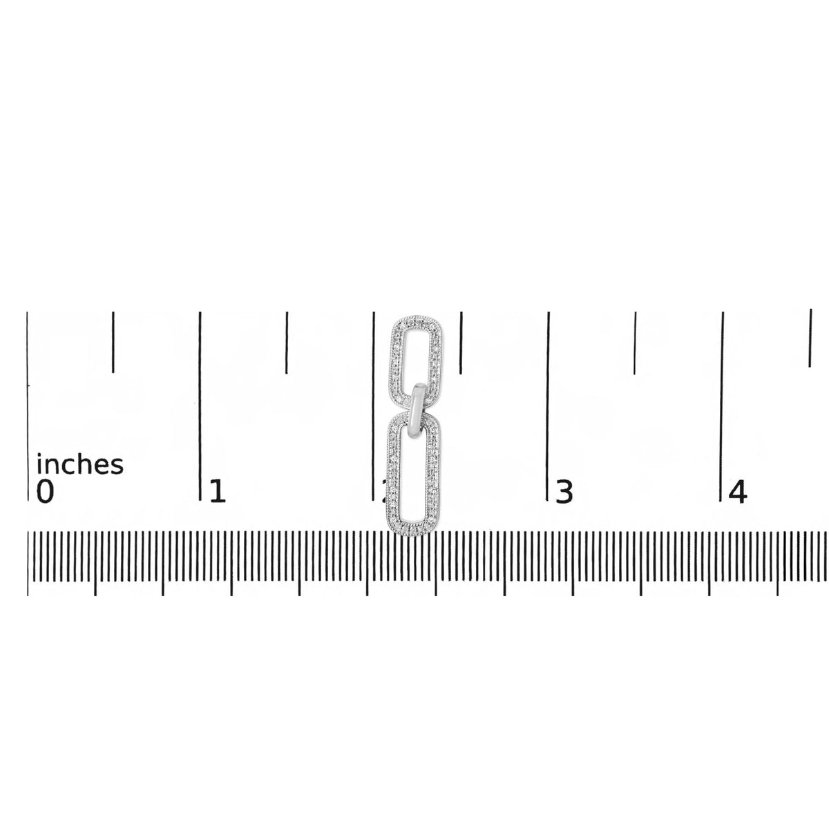 Close-up front view of a white metal earring with two rectangular linked shapes, each outlined with small white gemstones in a pave setting, shown on a scale.