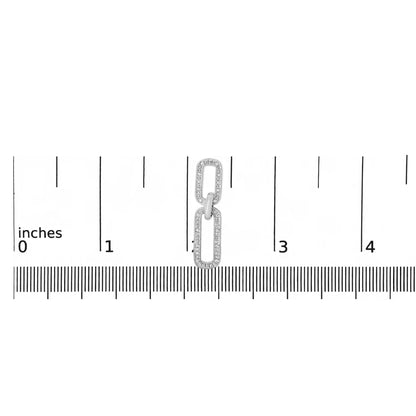 Close-up front view of a white metal earring with two rectangular linked shapes, each outlined with small white gemstones in a pave setting, shown on a scale.