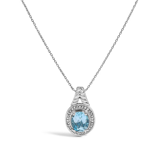 Close-up front view of a white metal necklace pendant with an oval blue gemstone surrounded by round white gemstones in a prong setting, shown on a white background.