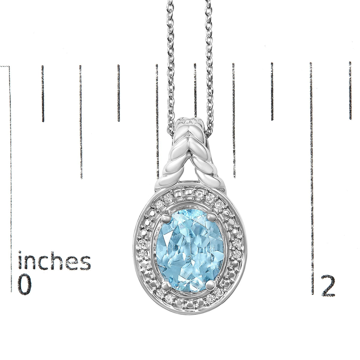 Close-up front view of a white metal oval pendant necklace displayed on a scale, featuring a central blue oval gemstone surrounded by a halo of small round white gemstones and braided chain detail.