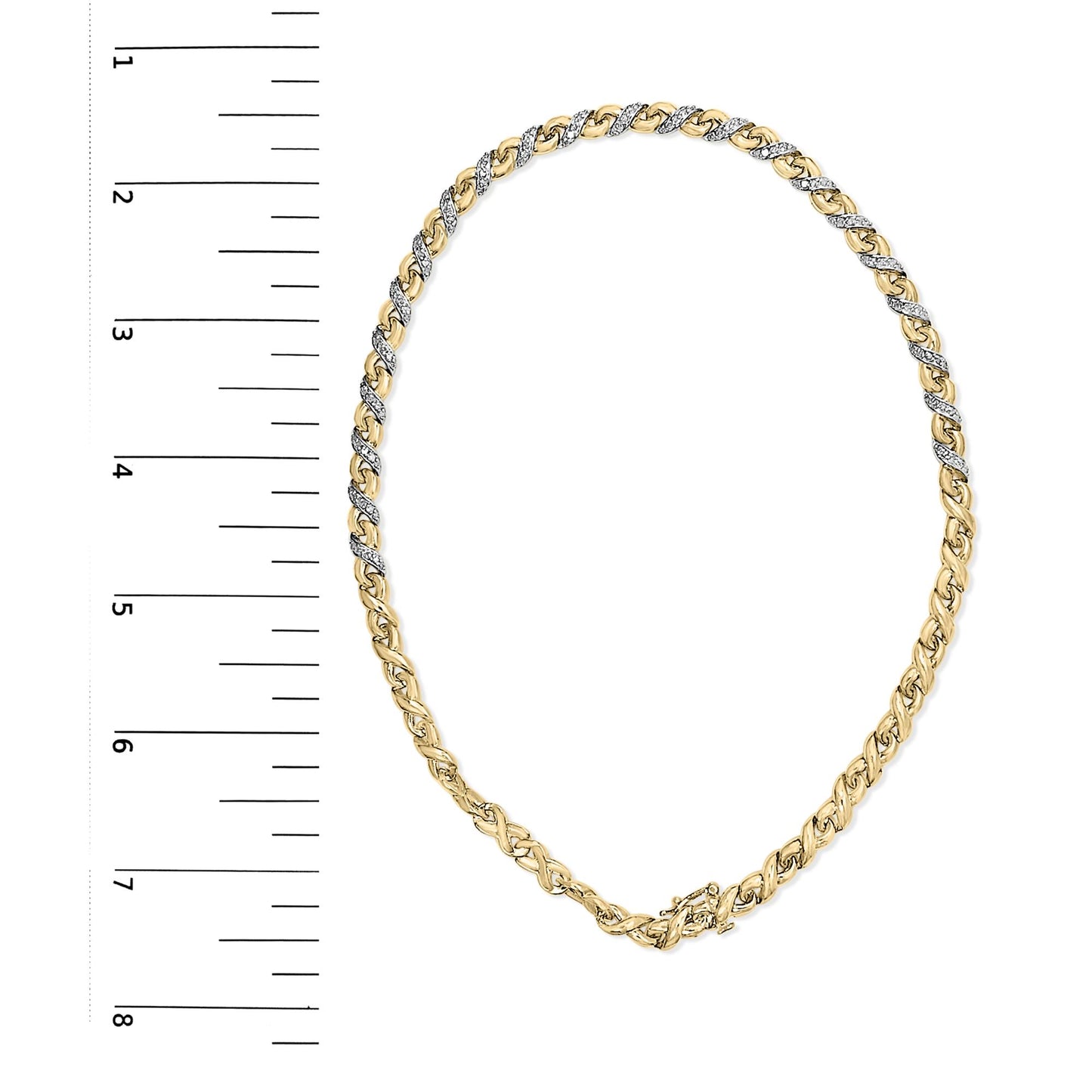 Top-down view of yellow metal necklace with alternating sections of white gemstones in prong settings, displayed on a ruler for size reference.