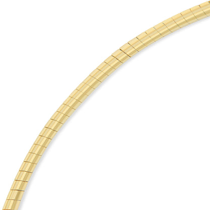 Close-up angled view of a yellow and white metal necklace with rectangular links.