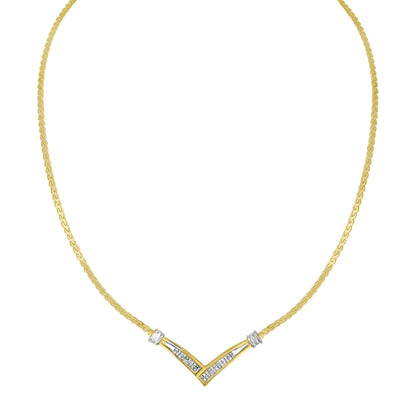 Front-facing shot of a yellow and white metal necklace with a V-shaped pendant featuring white princess-shaped gemstones in an invisible setting.