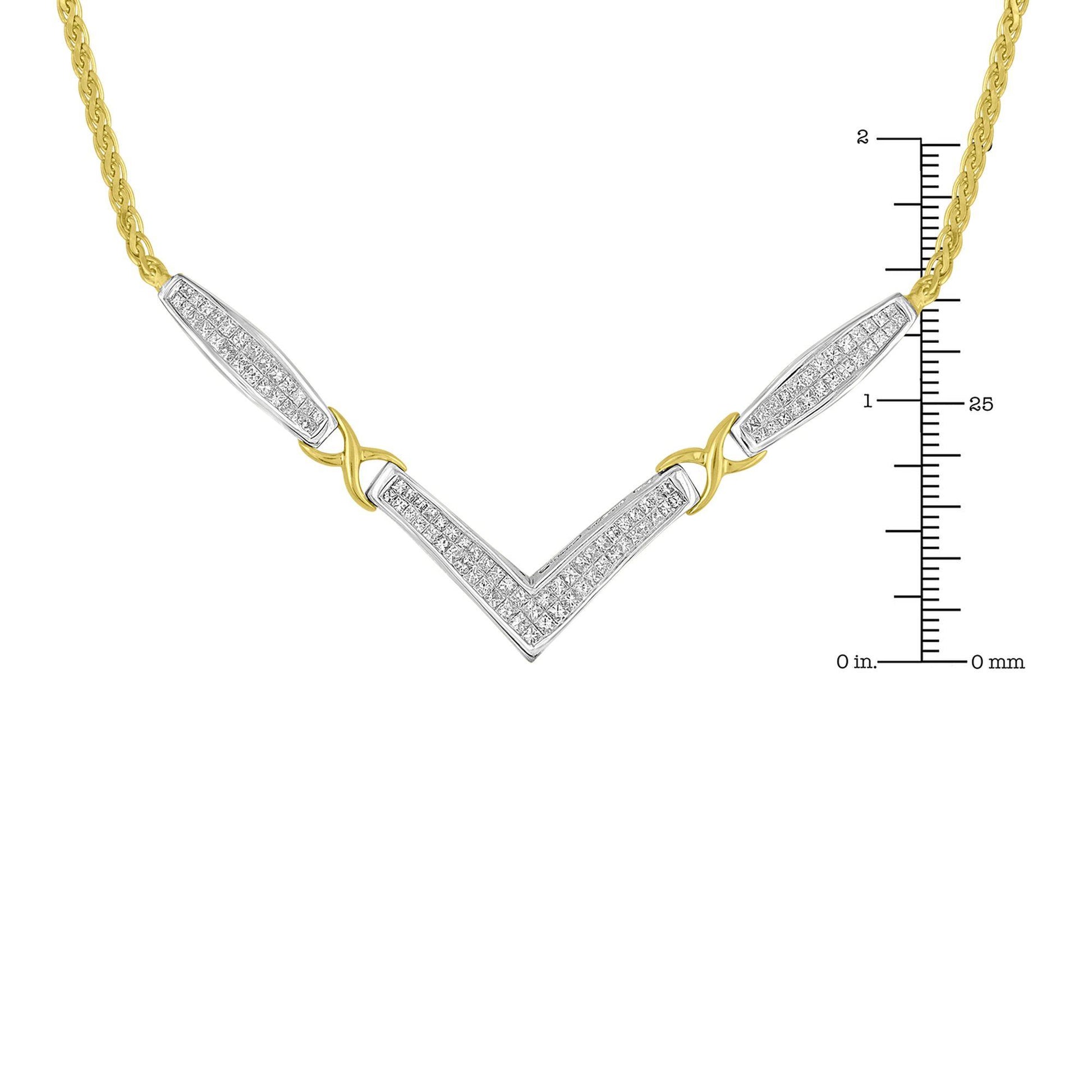 Close-up front view of a two-tone necklace with yellow and white metal featuring a V-shaped pendant with white gemstones in invisible setting and sections of yellow metal chain, shown on a ruler for size reference.