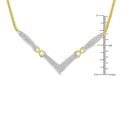 Close-up front view of a two-tone necklace with yellow and white metal featuring a V-shaped pendant with white gemstones in invisible setting and sections of yellow metal chain, shown on a ruler for size reference.