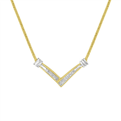 Front-facing shot of a V-shaped yellow and white metal necklace with channel-set white princess-shaped gemstones in the center.