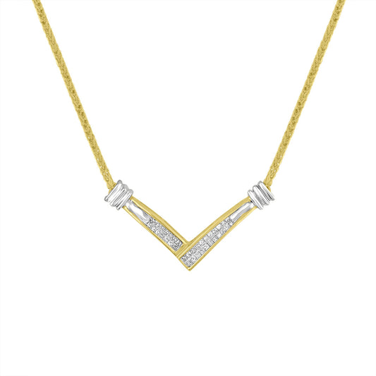 Front-facing shot of a V-shaped yellow and white metal necklace with channel-set white princess-shaped gemstones in the center.