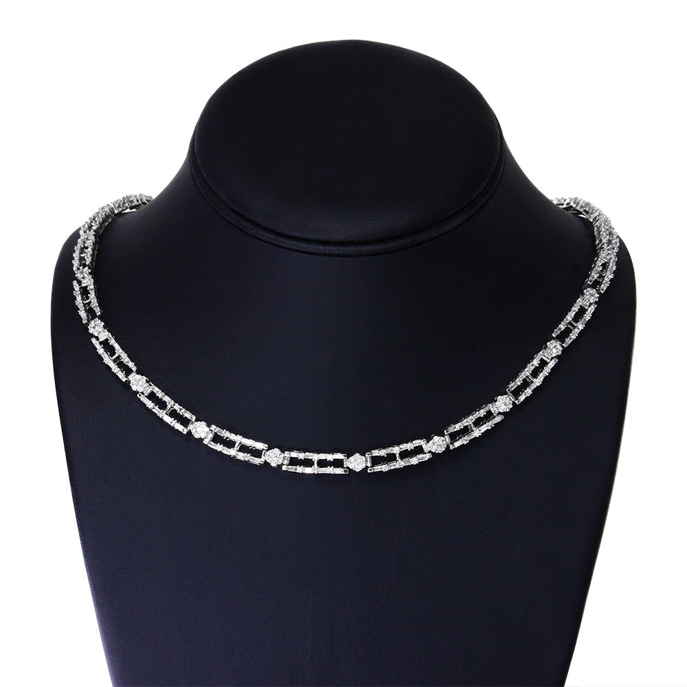 Front view of a white necklace on a black display stand featuring baguette-shaped white gemstones in prong settings linked with round white gemstones in channel settings.