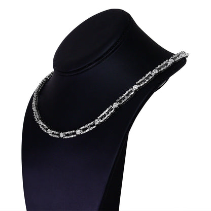 White metal necklace with alternating baguette and round white gemstones, displayed on a black necklace bust, shown from a slightly angled front view.