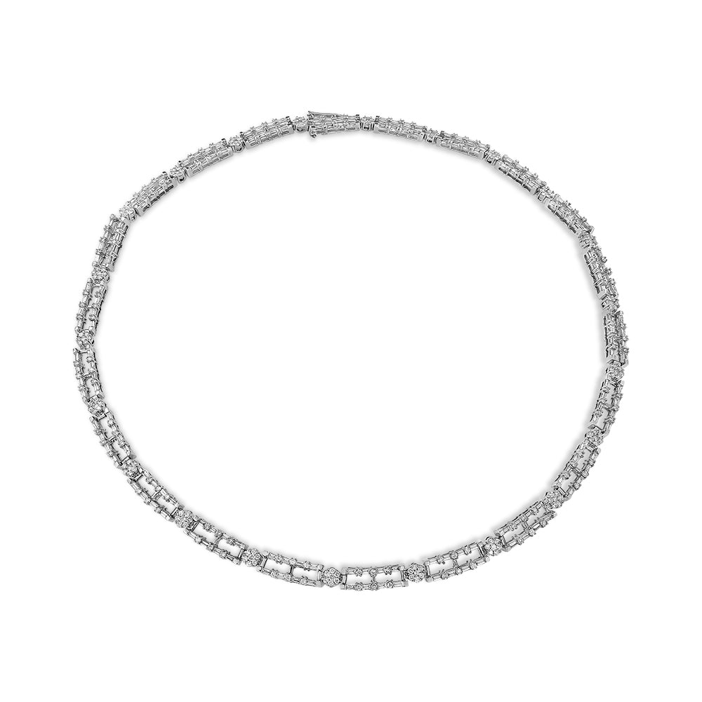 Top-down view of a white metal necklace featuring baguette-shaped white gemstones in prong settings interspersed with round-shaped white gemstones in channel settings.